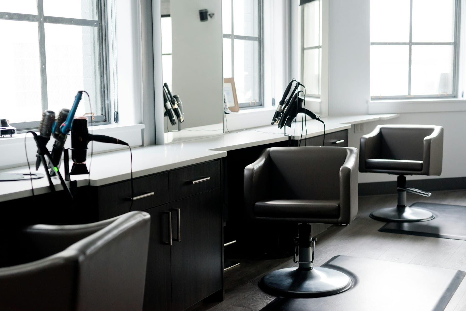 A modern barbershop interior with styling chairs
